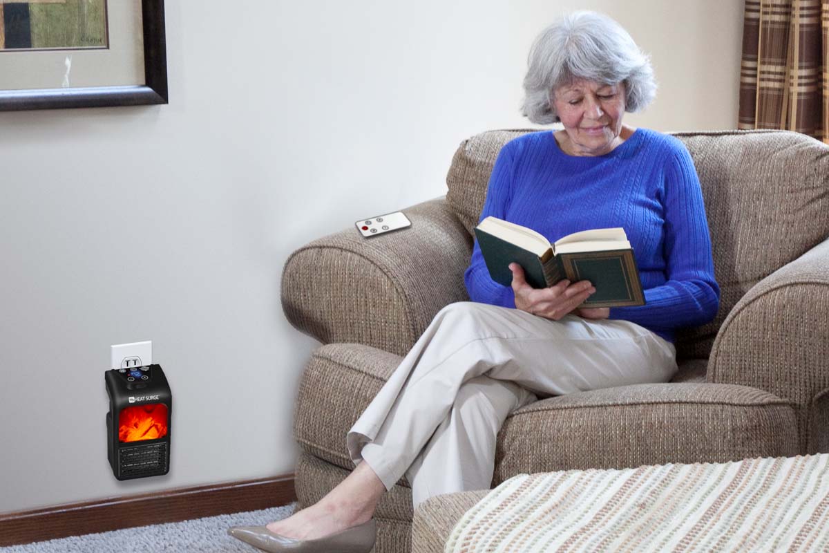 A woman reading a book on a lounge chair with a MiniMax plugged in beside her