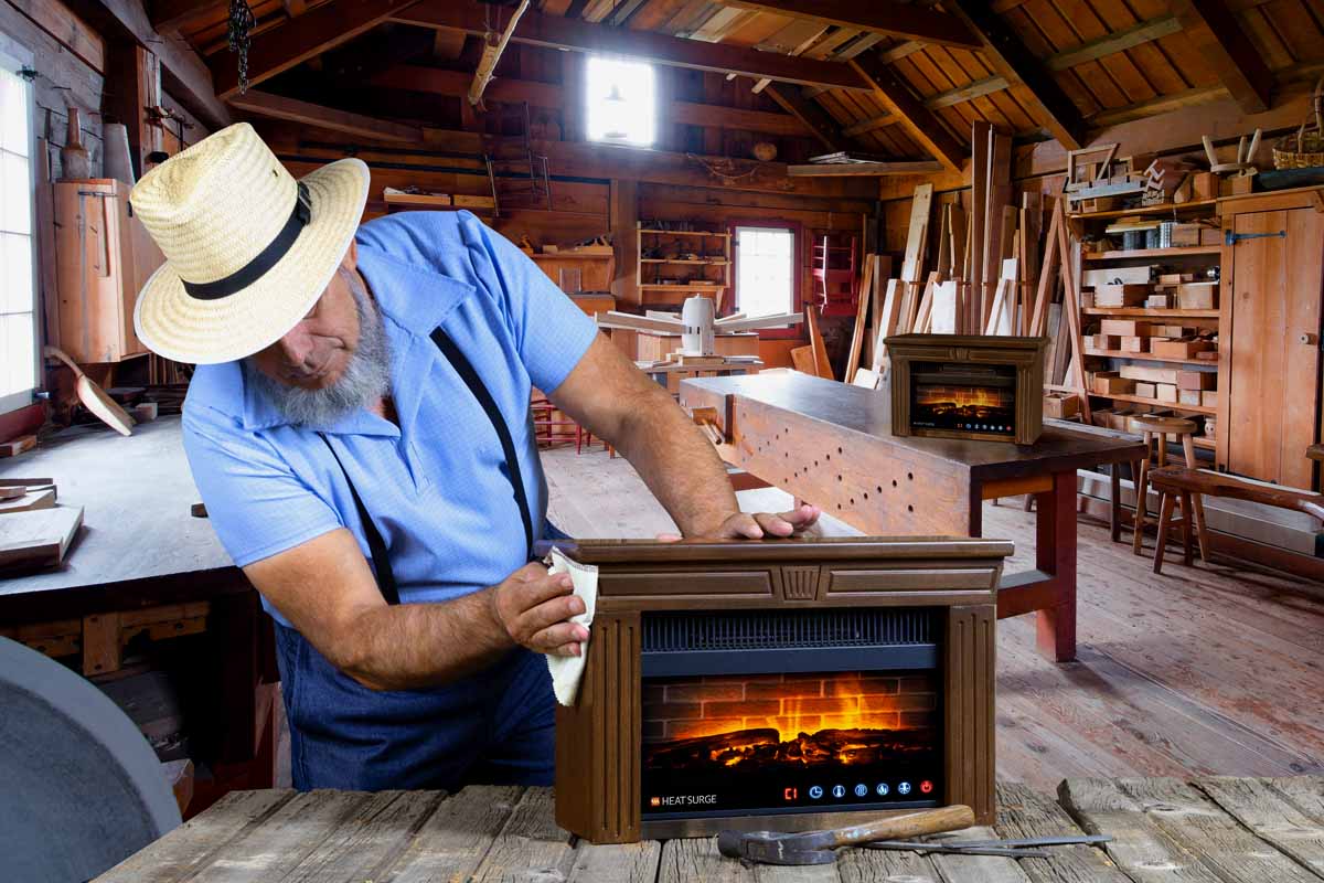 An Amish craftsman in a workshop with an Amish Multi-Color Mini Glo Widescreen on the workbench in front of him